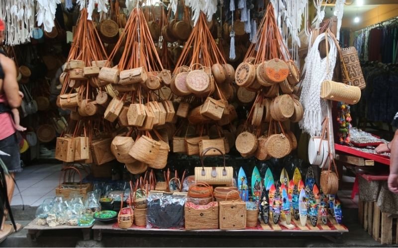 Rows of Balinese rattan bags displayed at the Ubud Art Market