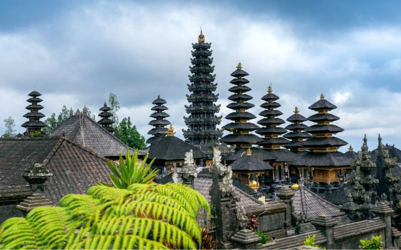 historic temple tops with distinct Balinese architecture and some surrounding walls and greenery