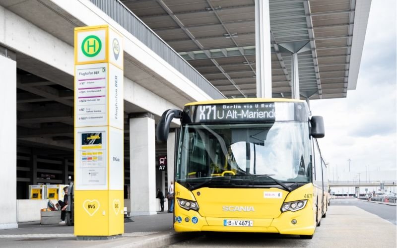 yellow public bus at an airport terminal