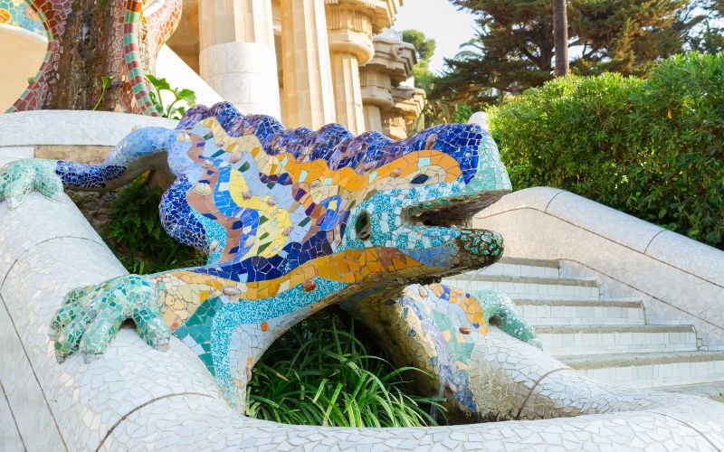 bright blue, aqua and orange lizard made from mosaics set amongst a historic building