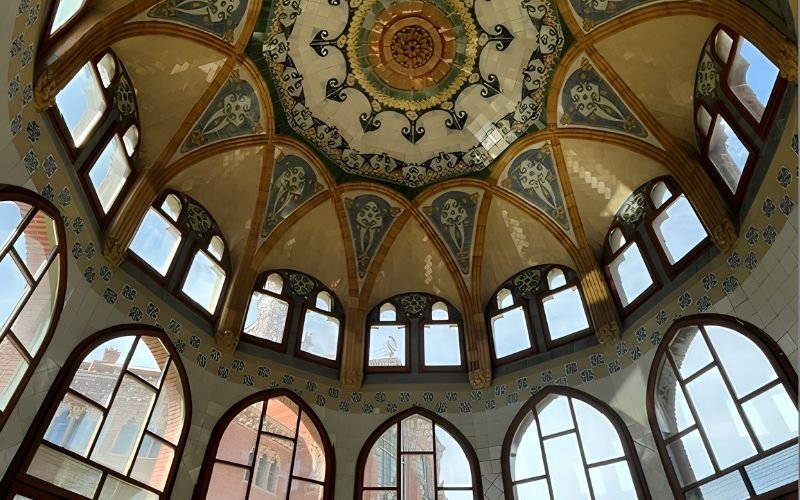 decorative tiled roof of a dome with many arch shaped windows