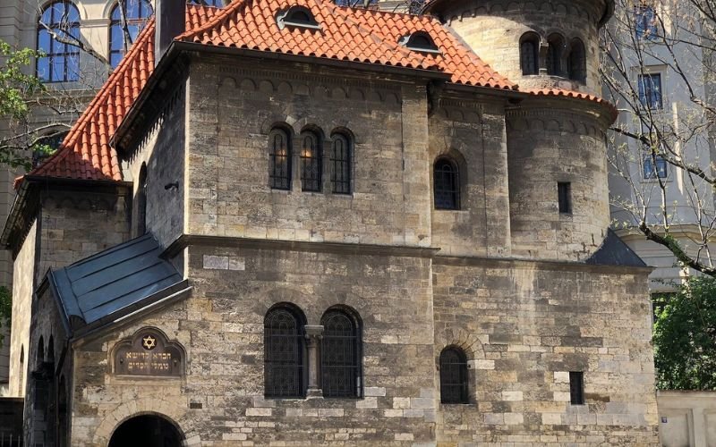 Exterior of a Jewish Synagogue with old stone work, terracotta tiled roof and arched windows