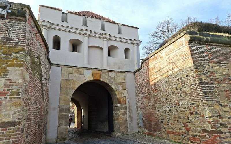 grand fortress with an arched entrance made from thick sandstone blocks