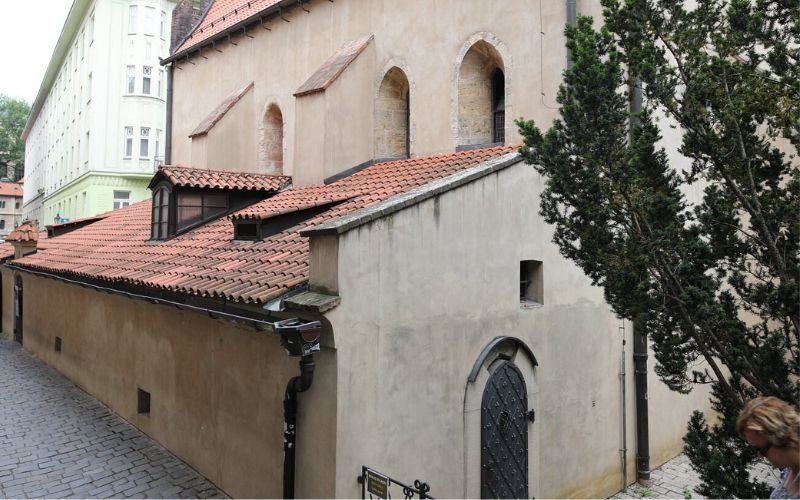 old quaint synagogue with arched door entryway and terracotta tiled roof